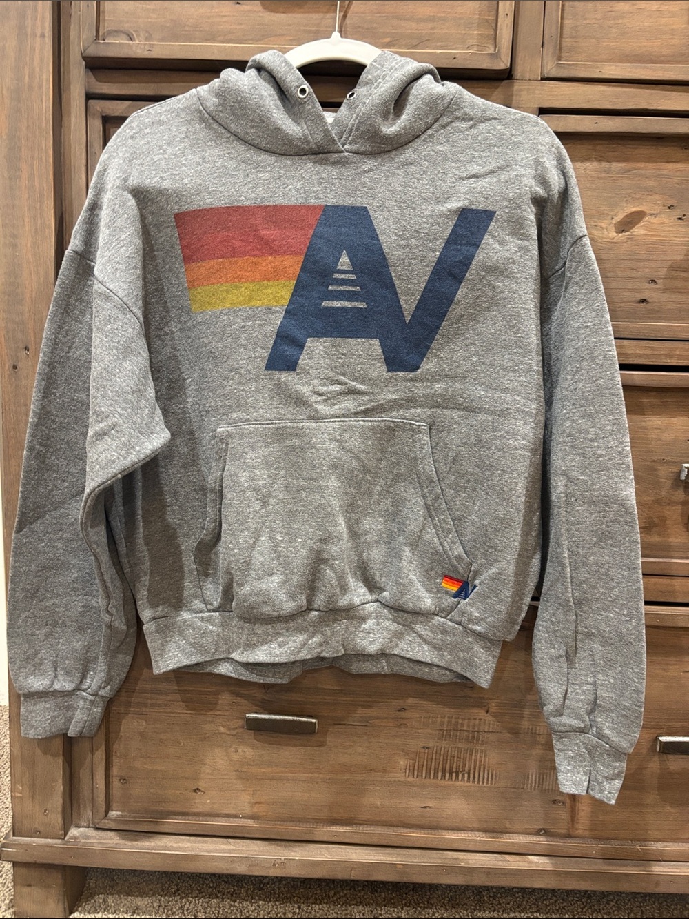 Aviator Nation Gray Hoodie with Navy Logo and Red-Orange-Yellow Stripe